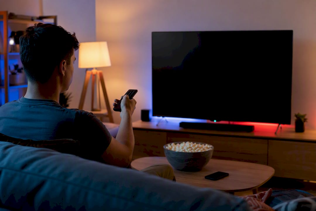 Hands using remote control for VOD navigation