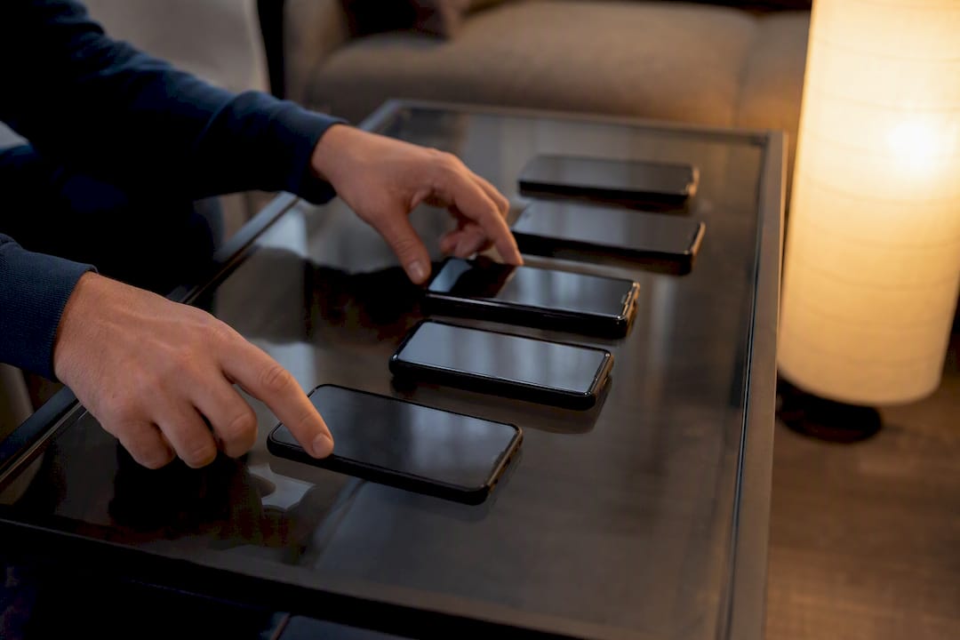 Hands interacting with smartphones for IPTV app comparison