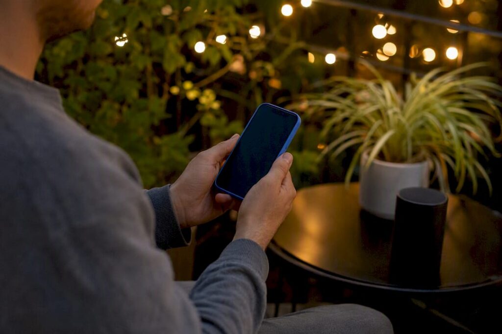 Hands setting up IPTV app on iPhone